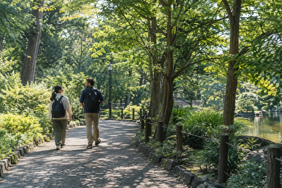 Japanese and international adult friends chatting during a relaxed walk through a leafy neighborhood park