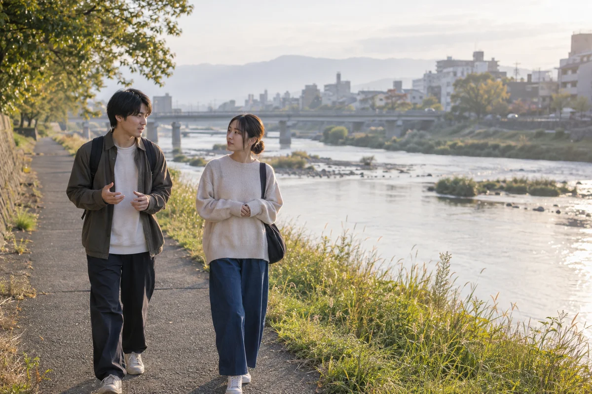 Two friends walking beside a river in Japan in soft morning light, listening to each other